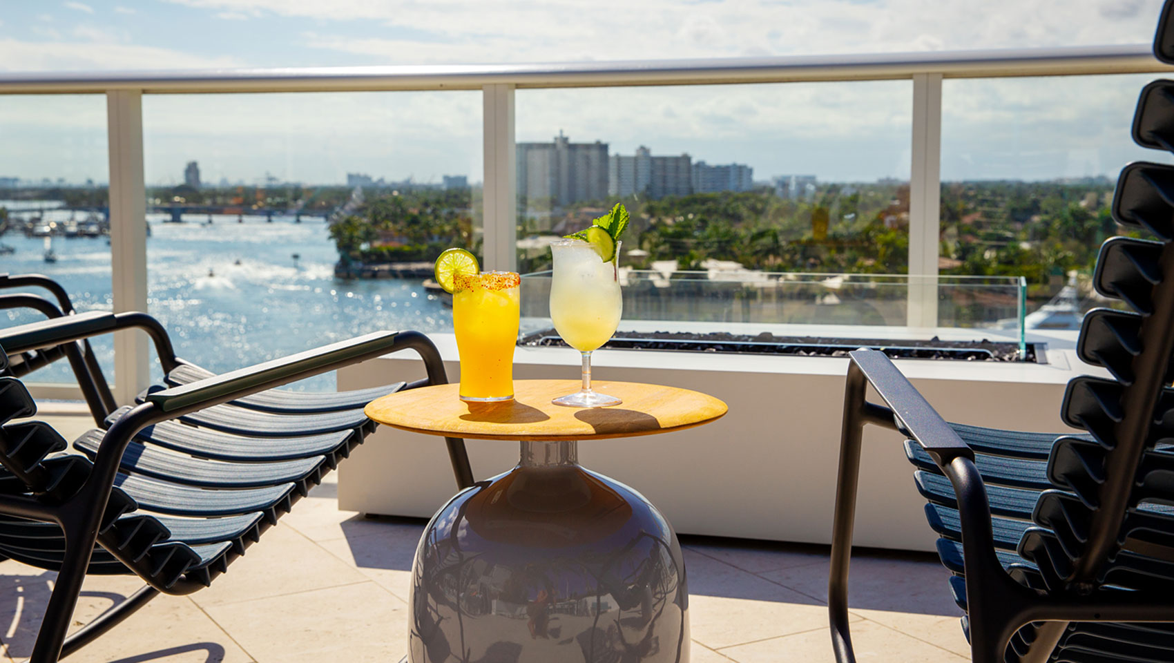 lounge chairs on the rooftop with two cocktails