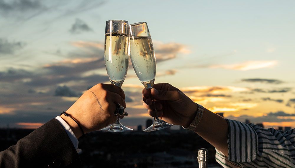 champagne cheersing at sunset