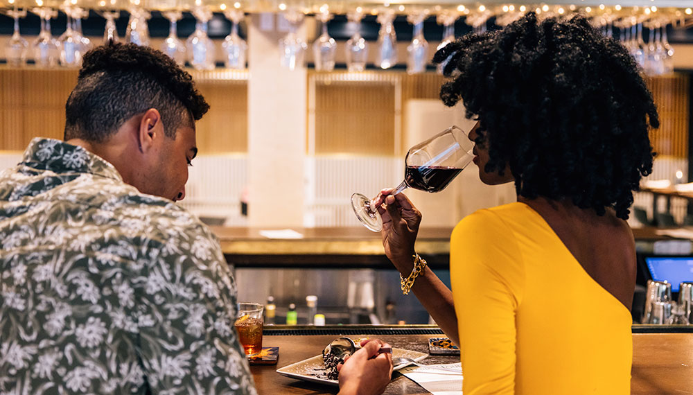 Man and woman dining at the bar