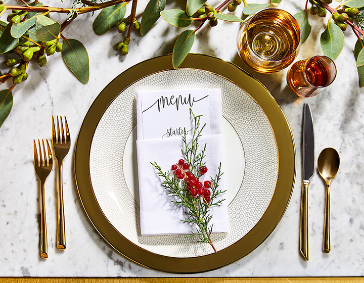 plated reception menu with foliage and silverware