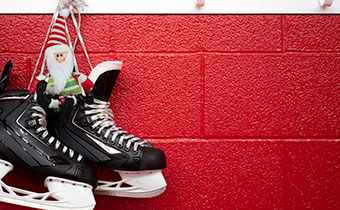 hockey skates hanging against a wall